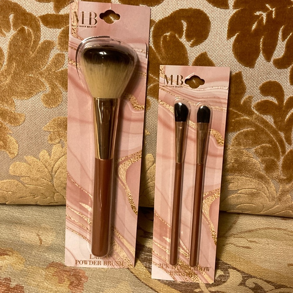 Set of three Must Have Beauty makeup brushes with matte rose gold handles.